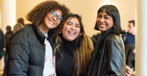 Three students smile for a picture