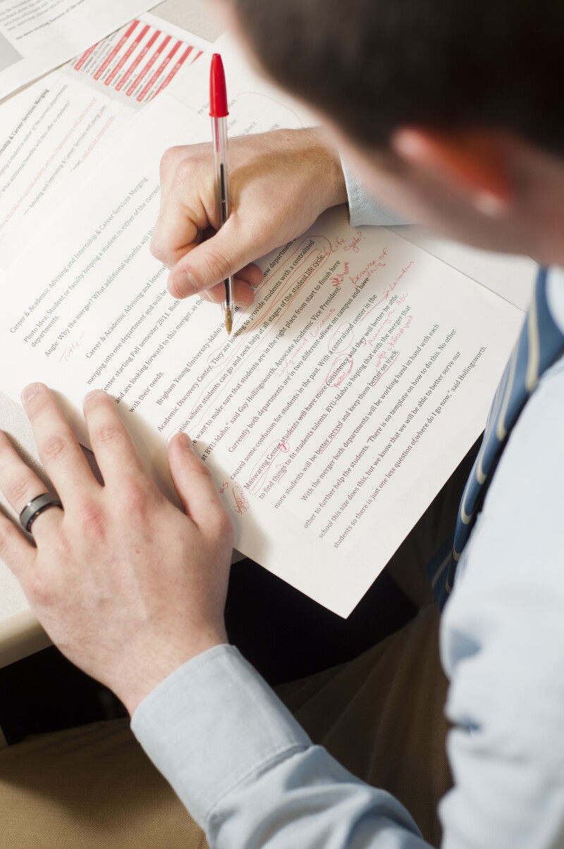 Still lives to illustrate the different Departments of University Communications. Student Employee for Writing and Editing, editing a statement.