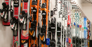 Different skis displayed on the wall