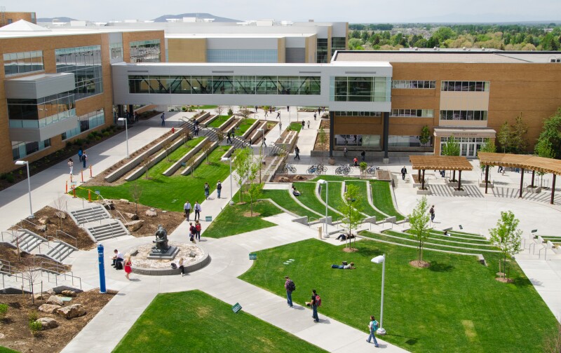 An aerial photo students walking across the Quad and Amphitheater with the Manwaring Center, McKay Library, and McKay Skybridge above.