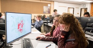 Students perform geological analysis on a computer in class