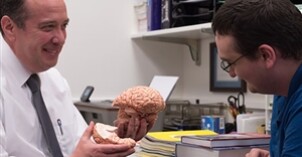 A professor discusses the human brain with a student.
