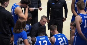The BYU basketball team in a huddle.