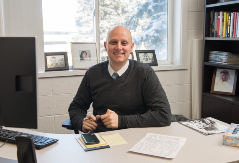 An admission advisor sits in his office