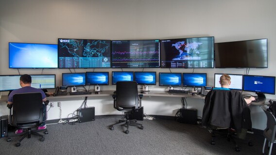 Students work in the Cyber Security room in the STC building.
