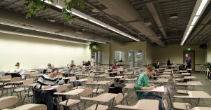 A few students sitting in desks at the BYU-Idaho Testing Center working on their tests.