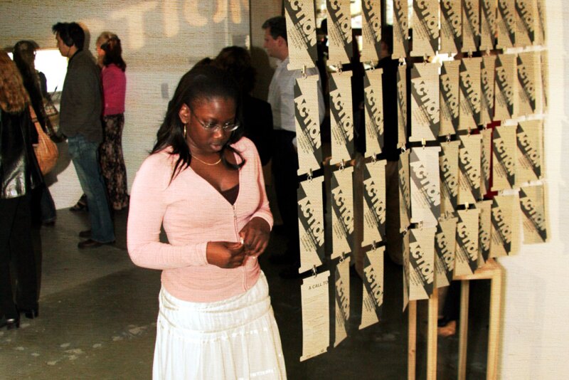 A female student looks a displayed art piece.