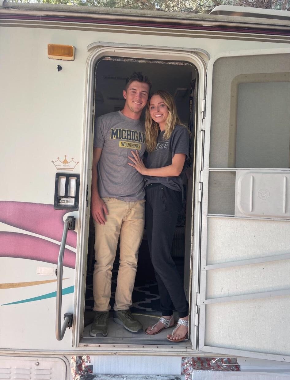 Man and woman standing inside an RV.