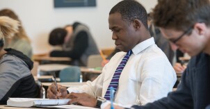 A BYU-Idaho student takes notes during a Math 101 class.