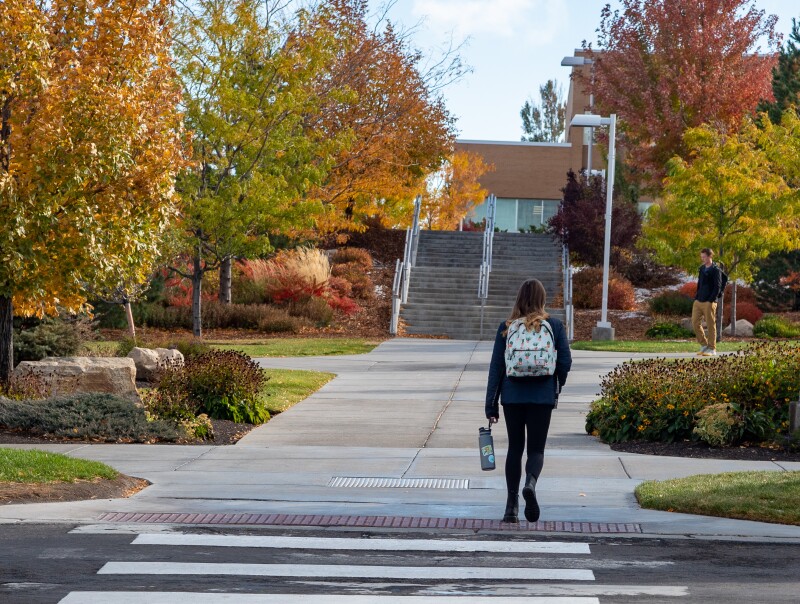 A BYU-Idaho student walking on campus 