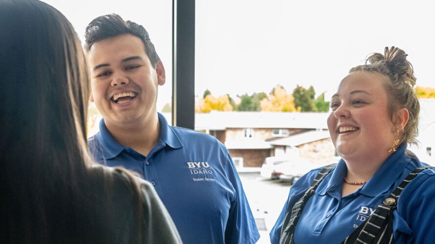 Two student mentors talking with a student