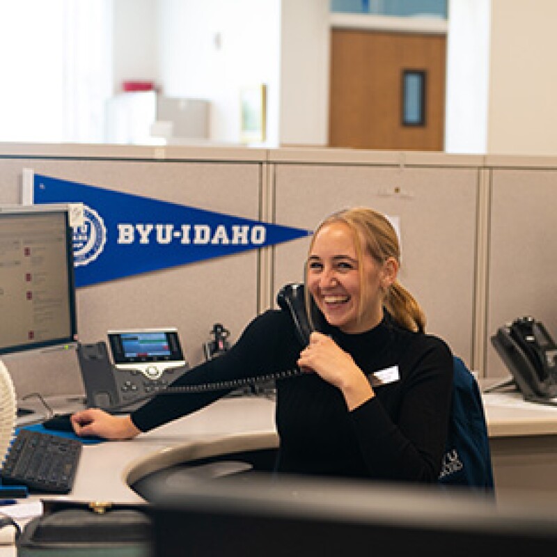 A BYU-I admissions rep on a phone call with a prospective student