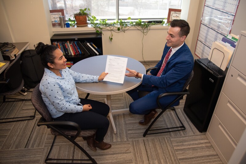 BYU-Idaho Career Center. Student handing out her resume.