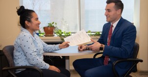 BYU-Idaho Career Center. Student handing out her resume to a worker there.