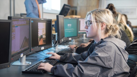 A Design and Construction Management student works on a computer.