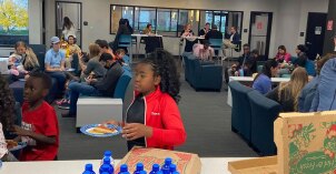 Community activity with people visiting and enjoying pizza.