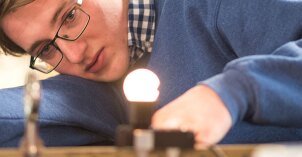 Physics Students work together to learn about light.
