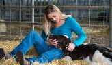 Britton Braithwaite caring for a calf at the Agriculture Science Center.