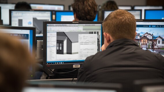 Design and Construction Management students use computers to make models of buildings.