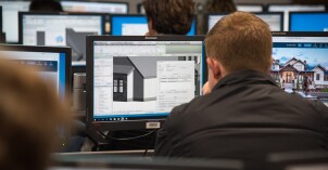 Design and Construction Management students use computers to make models of buildings.