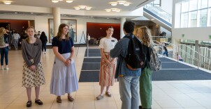 Students and missionaries gathered together talking to one another in the I-Center