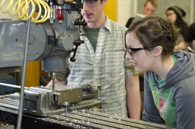 Students work with machinery in the Manufacturing Processes Lab.