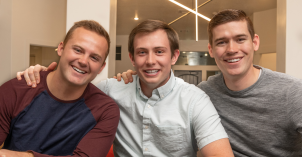 Three male students sit on couch in a student apartment at BYU-Idaho.