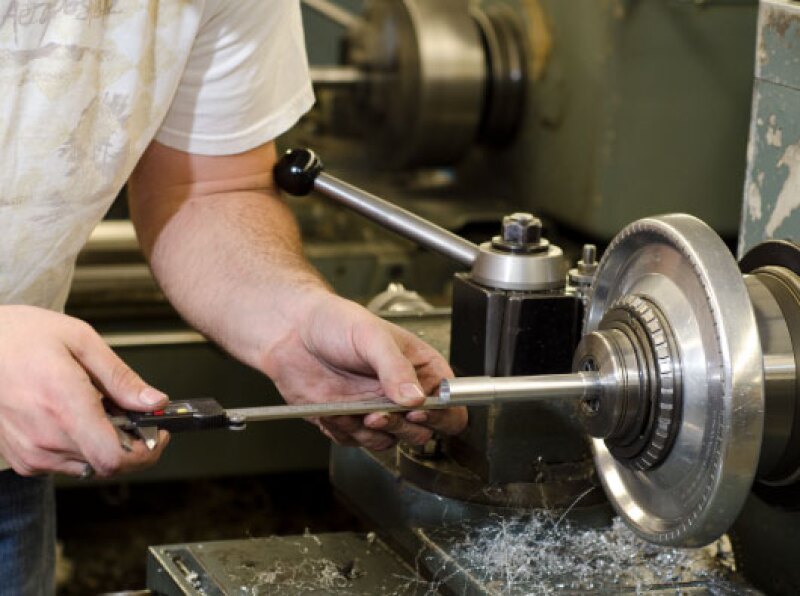 During an engineering technology lab, a student fine tunes a rotor.