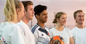 Students playing soccer at the upper filed.