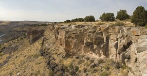 A group of geology students take a break on a field trip to a canyon
