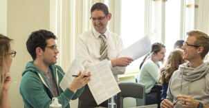 Students talk with a professor about Advanced Graphic Design content.