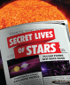 A newspaper in the foreground displaying a headline "Secret Lives of Stars" with a close-up of the sun in the background.