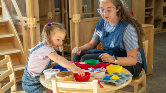 A home and family student plays with a young girl.