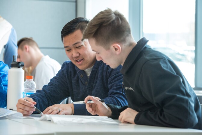 Students help teach each other the essentials of Human Nutrition in a lab.