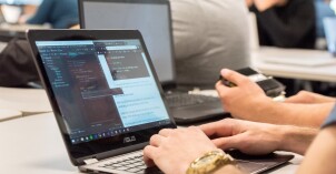 A BYU-Idaho student works on a web design program on a laptop.