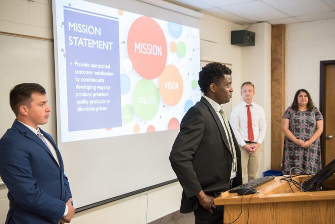 Dave Harrell, a faculty member of the Finance Department teaches BA 215, Business Essentials. That day the class was presenting their final group project.