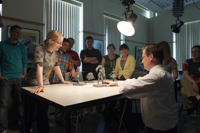 Brother Josh Abegglen critiques, with the help of his students, other students work from his Entertainment Illustration class.