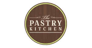 The Pastry Kitchen Logo "The PASTRY KITCHEN" written in off-white; dark wood slabs for background; light green outline.