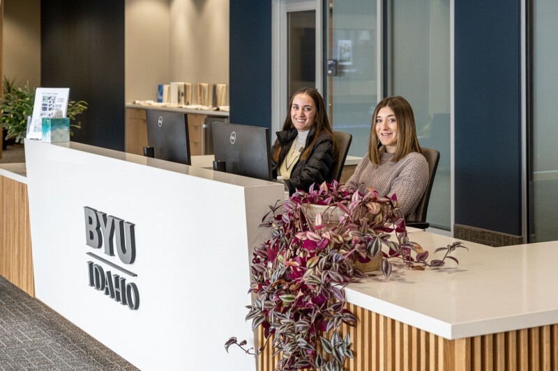 Two BYU-Idaho students at the Welcome Desk in the Manwaring Center