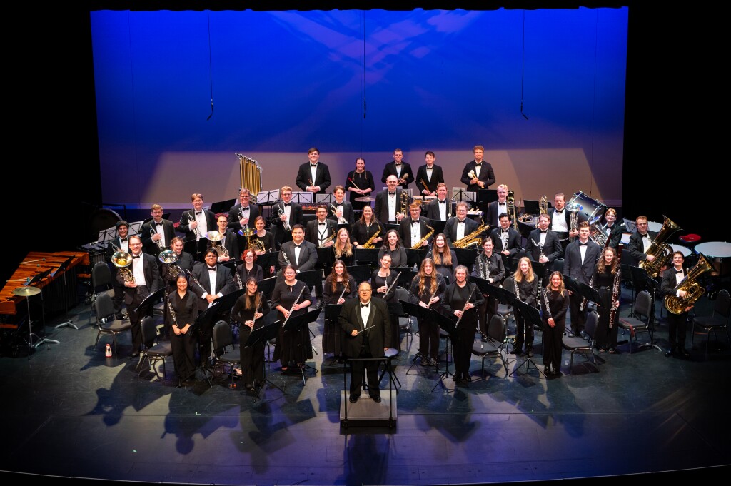 Band poses for a photo on stage.